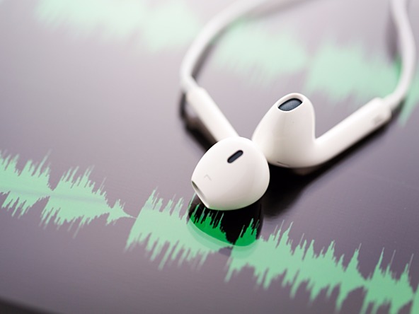 pair of headpones against soundwaves
